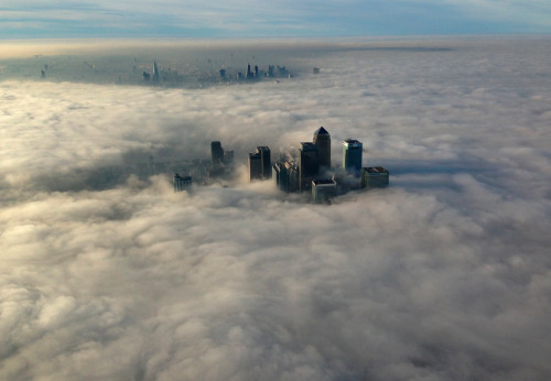 awkwardsituationist:  chicago fog The Canary Wharf business district of east London taken from the Metropolitan Police helicopter is seen during a foggy morning in this photograph received via the Metropolitan Police in London on December 11, 2013. —