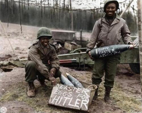 Two American soldiers proudly show off their personalized “Easter Eggs”, northeast France, during Ea