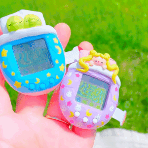 The custom Sailor Moon and Kuchipatchi Tamagotchi being held next to each other.