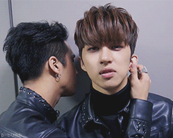 b-bumb - ravi stands next to ken holding his earlobe while he...
