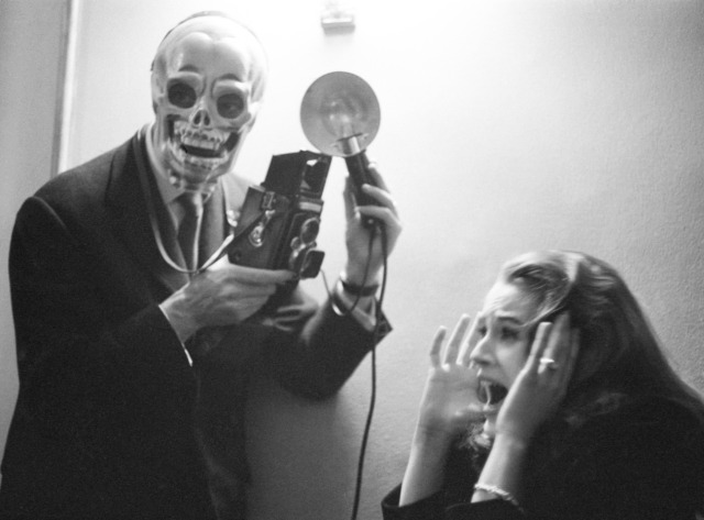 Actress Béatrice Altariba with photographers wearing skull masks at the premiere of the film 