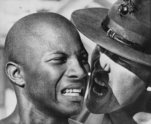 A US Marine recruit is yelled at by his drill sergeant. The recruits have to endure extreme physical