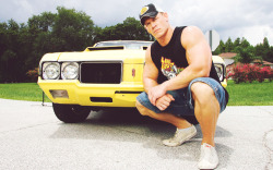 John showing off his muscles, and muscle cars! =D