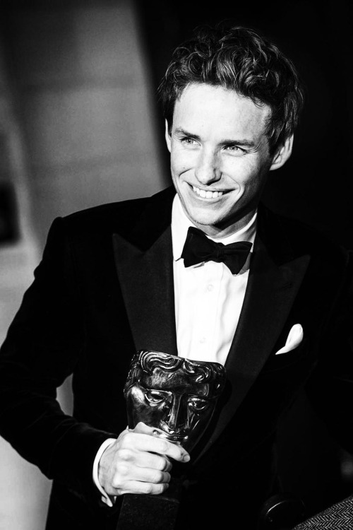 MASK OF ELATION: Eddie Redmayne savors his BAFTA win.