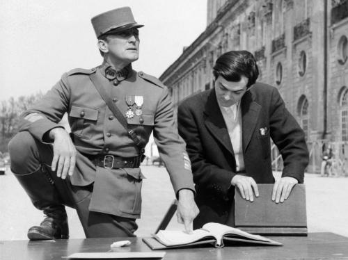 Kirk Douglas and Director Stanley Kubrick review the script on the set of Paths of Glory.