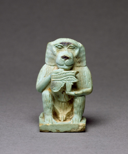 Statue of Thoth, ancient Egyptian deity of writing and knowledge, in the form of a baboon, holding a