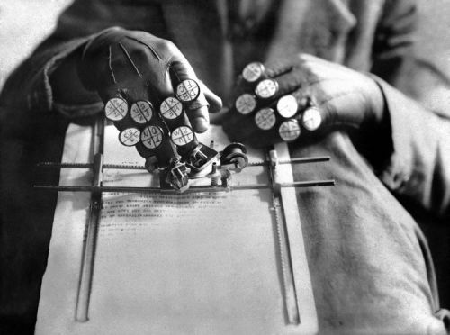 anyskin:   February 16, 1935 . Austrian inventor Alois Gamper demonstrates his invention - typewriter gloves for bookkeeping.