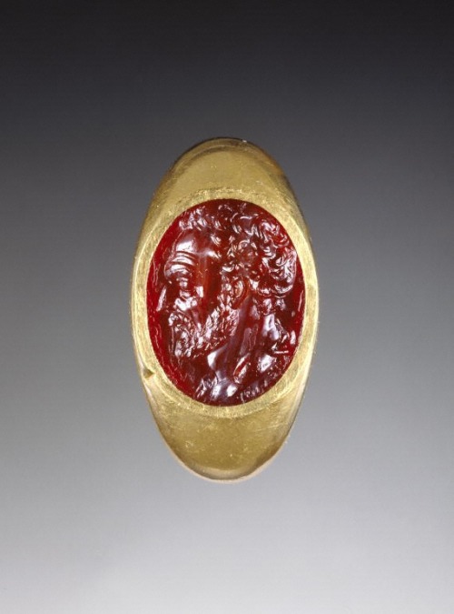Engraved cornelian gem inset into a gold ring, representing the head of Demosthenes, with drapery ov