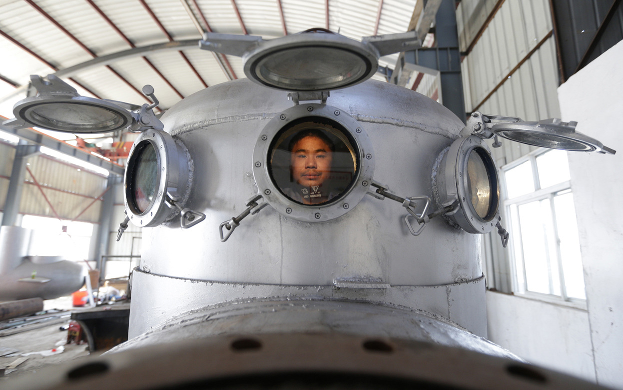 From Chinese DIY Inventions, one of 39 photos. Zhang Wuyi sits in his newly made multi-seater submarine at his new workshop near an artificial pool in Wuhan, Hubei province, China, on November 14, 2012. Zhang, a local farmer who is interested in...