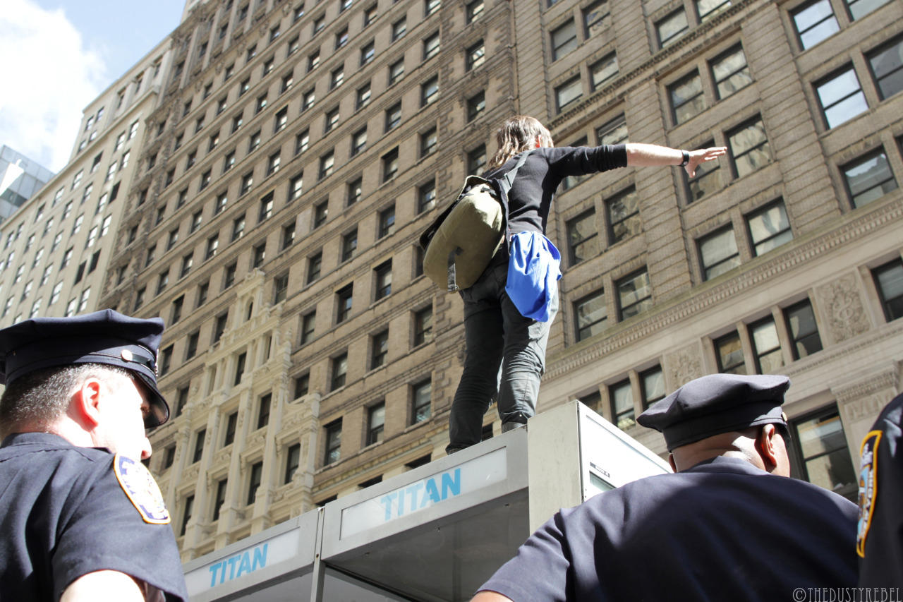 Flood Wall Street Protester on top of a phone booth, surrounded by police. Just after this he jumped and tried to run. After some chaos, he was arrested. (Financial District, NYC)
More photos from FLOOD WALL STREET on TheDustyRebel Facebook page.