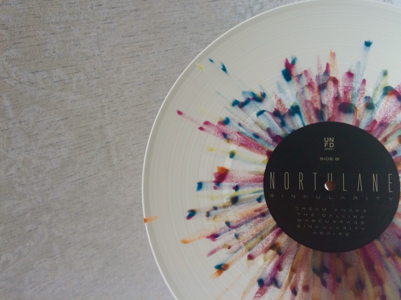 baconkids:  Northlane - Singularity Clear w/ Purple/Blue/Orange/Yellow Splatter /500