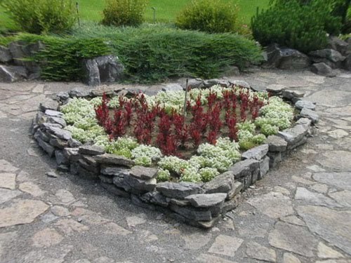 Hearts can be brought to the garden another way, by adding them to the design of the space. I love how these stones were arranged in the shape, drawing one’s eye to the plants in the center.