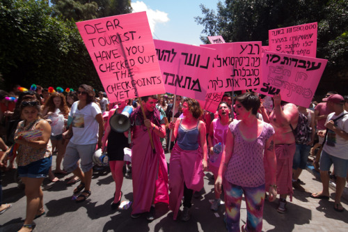 chubbygurl:  occupiedmuslim:  bidyke:  Today, on the Tel Aviv Pride Parade, our queer-anarchist activist group, Mashpritzot, protested against pinkwashing and the “gay” community’s priorities. The group painted themselves pink in protest against