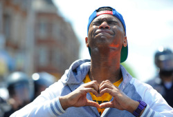 wolfspirals:  Devante Hill makes a heart with his hands after he was hit with pepper spray by police on Tuesday, April 28, 2015, in Baltimore, MD