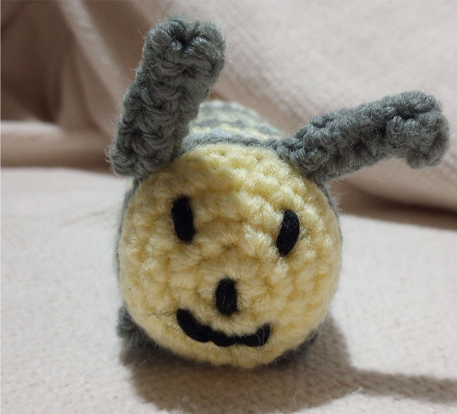 crochet caterpillar face. it's smiling!