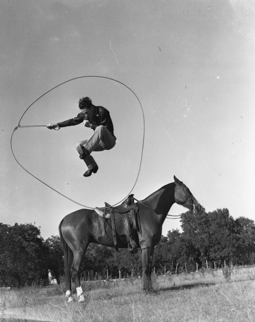 humanoidhistory:Cowboy jumps ten feet in the air over the horse, looping himself inside his lasso, n