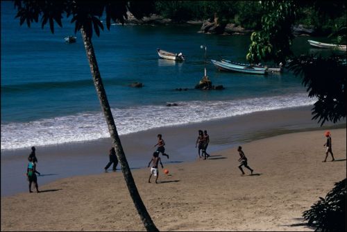 africansouljah:Ian BerryTRINIDAD. Nr Port of Spain. Fishermen enjoy a football game on the beach. 19