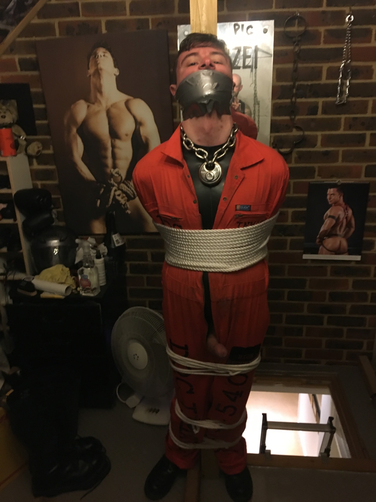 jamesbondagesx: Intruder in uniform and secured in sleep sack, tied to post and milked