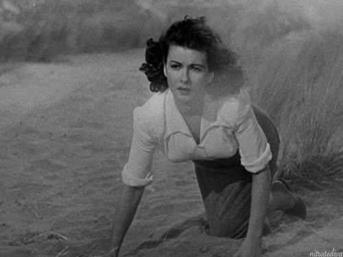 Joan Bennett in Jean Renoir’s The Woman on the Beach (1947). #1940s#joan bennett#jean renoir #the woman on the beach #film noir#noir #woman on the beach #rko#wind#glamour#old hollywood#windblown#beach#sand dunes
