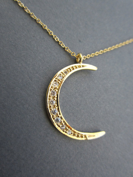 wickedclothes:  Crescent Moon Necklace Simple yet elegant, this crescent moon pendant is gold-plated and is embedded with CZ crystals. Accompanied by a tiny star charm. Hung on a gold-filled chain available in various lengths. Sold on Etsy.