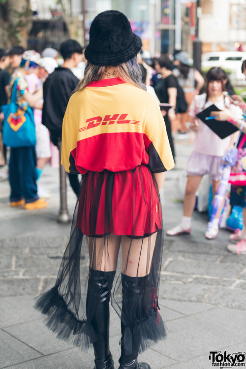 tokyo-fashion:  Japanese high school student SaraH on the street in Harajuku wearing a belted DHL shirt with a handmade sheer skirt, Demonia lace-up boots, a fuzzy Kangol bucket hat, and floral Eastpak crossbody bag. Full Look