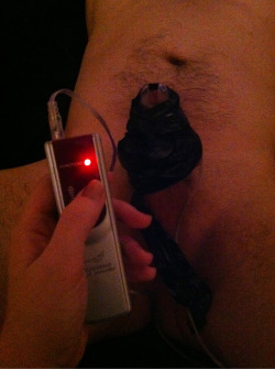 devotionanddomination:  On full power and taped to his cock while he is in chastity. 