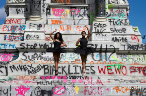 Ballerinas on the defaced monument of Confederate general Robert E. Lee in Richmond, Virginia, on Ju