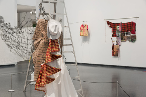 This assemblage stands at the intersection of sculpture, painting, and fashion. Organically draped t