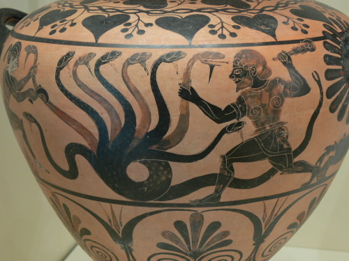 Heracles, assisted by his nephew Iolaos, fights the Lernaean Hydra, using a battle tactic that schol