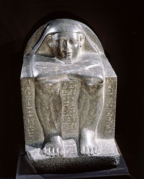 Cube Statue of HetepIn this example of a block statue made of granite, Hetep is wearing a smooth, fl