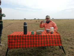 <p>Coffee in the middle of the Serengeti.  That view behind me is the same 360 degrees… Wildlife abound. </p>