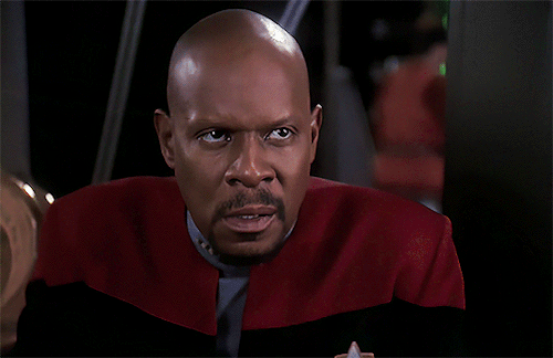 Benjamin Sisko reacts to Jadzia's confession by putting his face in his hands and closing his eyes.