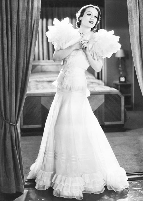 deforest:Joan Crawford in the revolutionary “Letty Lynton dress” designed by Adrian. Photo by George