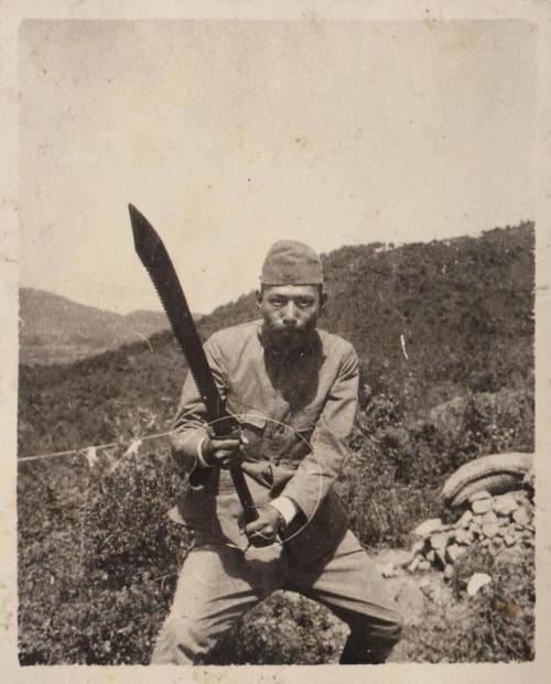 historicaltimes:Japanese soldier holding a captured Chinese dadao, 1930s via reddit