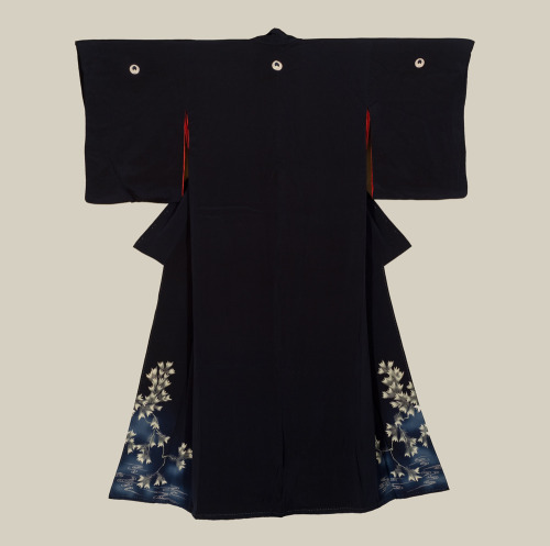 A fine soft silk kimono featuring yuzen dyed flowers with embroidered highlights at the base.  Late 