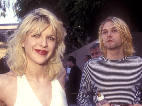 nirvananews:  “Sorry about this zit..” - Courtney Love says, wearing an engagement ring from 1906 with a ruby centered in the middle.“Zits are beauty marks.” - Replies Kurt Cobain.Read More on The Love/Cobain Relationship.