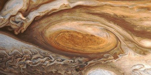 Jupiter is perpetually covered with clouds composed of ammonia crystals and possibly ammonium hydros