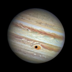 sixpenceee:  On April 21, 2014, the Hubble telescope captured what looks like a black hole in Jupiter’s Great Red Spot — but really, it’s the shadow of the Jovian moon Ganymede. (Source)  Jupiter&rsquo;s Eye is looking at you o.o
