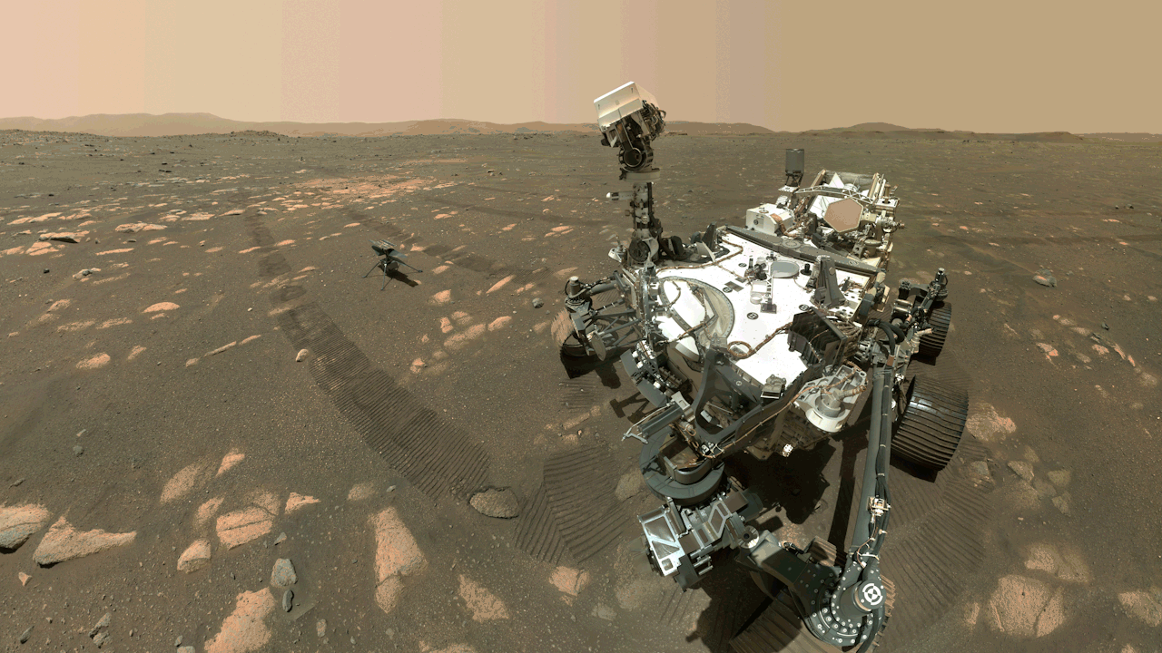A color-animated image sequence of NASA’s Mars Perseverance rover shows the vehicle on Mars's red, dusty surface. The six-wheeled rover’s camera “head” faces the viewer and then turns to the left, where, on the ground, sits the small Ingenuity Mars Helicopter. Credit: NASA/JPL-Caltech/MSSS