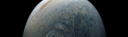 Space out for a moment. Swirling clouds in a Jupiter jet stream are captured in the center of this c