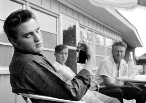 Elvis Presley sitting on the porch of his home at 1034 Audobon Drive, Memphis, Tennessee, July 4, 19