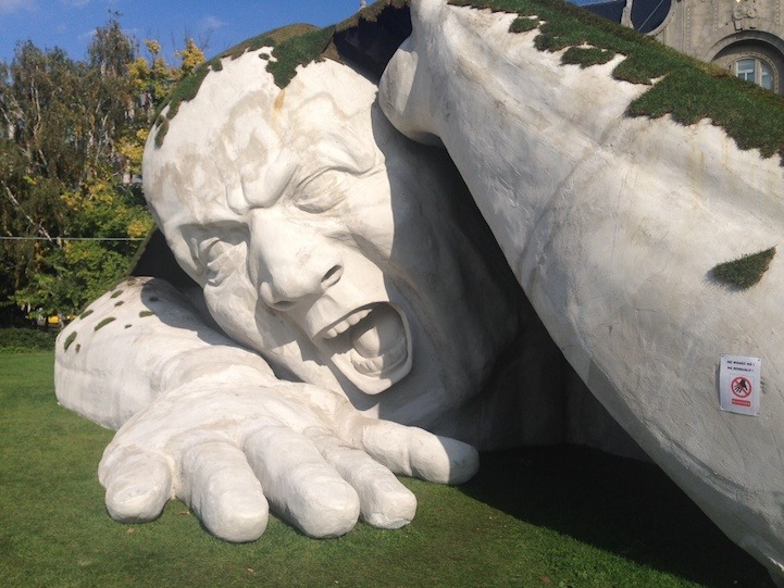 mymodernmet:  A gigantic man crawls out from the earth in this spectacular outdoor