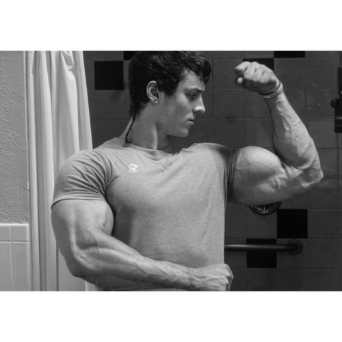 beautifulyoungmuscle:The stunning flexed biceps of Zach Zeiler. Piled high with muscle, studded with veins, rippling with mass and power, they’re erotic totems of beautiful young muscle.