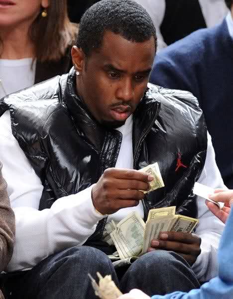 thesnobbyartsyblog: thesnobbyartsyblog:  The most inspiring picture I ever saw was when Diddy was at the Knicks game with a bunch of money on his lap and he’s holding a dollar bill like “Wtf is this?” I love that picture so much. It’s the most