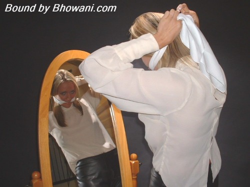 graybandanna:  Lucy Zara gags herself in the mirror with a white scarf before being tied to a chair, gagged with another scarf and blindfolded 