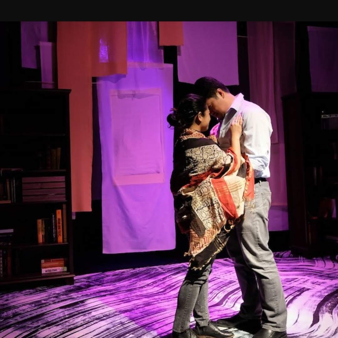 Pictured: two actors, Akiko and Patrick, in my play DEVOTED having an authentic moment on stage about to kiss... or won't they?