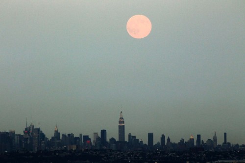 Porn  A full moon rises over the skyline of New photos