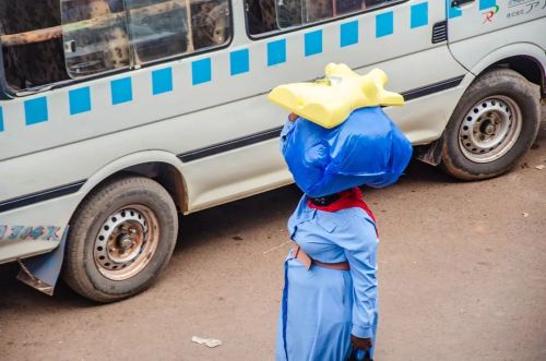 Following the full reopening , the streets of Kampala are slowly getting back to life. A lady with a