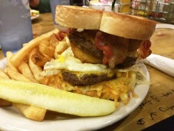 superchocbear:  The Farmer Jon:  Double cheeseburger with bacon, hash browns, a fried egg and an onion ring.   My boyfriend is such a fat fuck, and I couldn&rsquo;t love him more for it! Look at this burger he got!