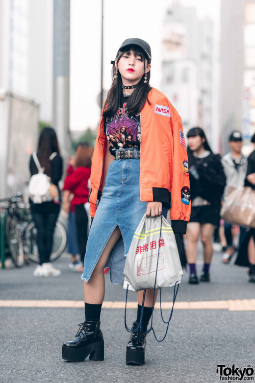 15-year-old Japanese student Kaya on the street in Harajuku wearing a NASA bomber jacket over a Slip